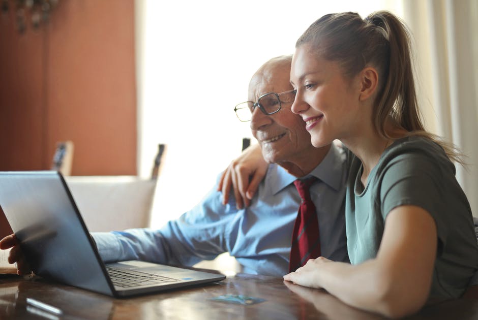 elderly-man-with-granddaughter Senior woman and caregiver in kitchen