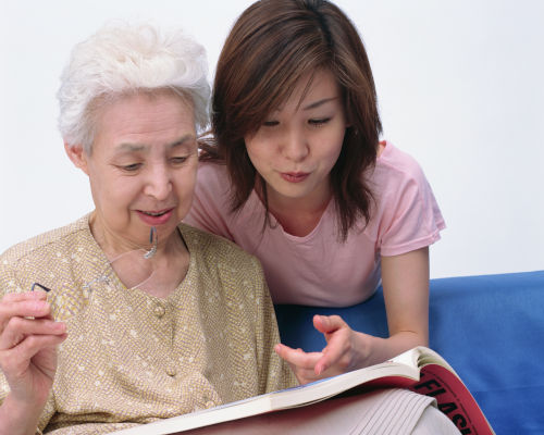 Asian caregiver elderly woman